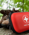Red mini hard-shell first aid kit with white cross, water-resistant case for travel and outdoor use.