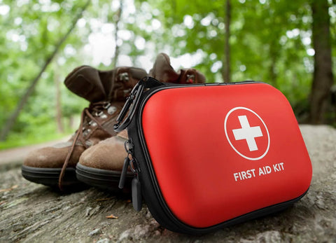 Red mini hard-shell first aid kit with white cross, water-resistant case for travel and outdoor use.