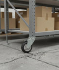 Heavy Duty Swivel Plate Caster Replacements Crafted From Solid Steel, Tough As Nails Casters on cracked concrete under shelves.