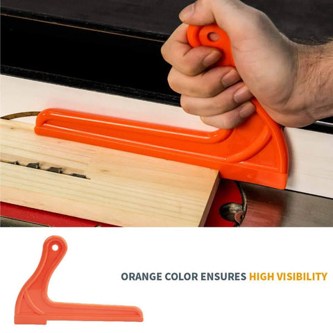 Hand using an orange push stick from the Table Saw Safety Accessories 6-Piece Set With Push Block, Push Sticks And Taper Jig For Router Tables.