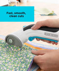 4V Max Cordless Fabric And Craft Cutter Rotary Tool with USB, self-sharpening blade cutting floral fabric, comfort grip in use.