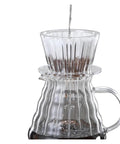 Straight Fire Premium Glass Pour Over Coffee Dripper Boasts Crystal Eye Viewing Window, pouring hot water over coffee grounds.