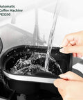Person filling the water reservoir of the No Sweat Fully Automatic Bean To Cup Coffee Maker Featuring A Built In Grinder.