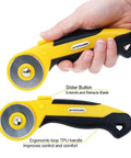 45Mm Rotary Cutter Kit With 9 Extra Blades For Fabric Quilting And Crafting, Including Five Straight Blades, Two Pinking Blades, And Two Skip Blades, Safety Sliding Button For Easy Blade Exposure in hand showing slider button.