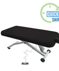 EarthLite Ellora Electric Lift Massage Table With Flat Top And Black Finish, featuring electric height adjustment and smooth wheels.