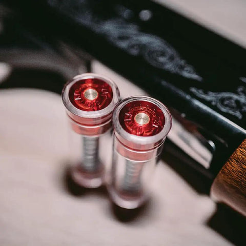 Close-up of shotgun snap caps 12 gauge with false primer reusable dry fire practice aids in metal holder