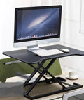Portable Sit Stand Desk Converter With Heavy Duty Dual Tray Ergonomic Stand that raises monitors and includes a keyboard and mouse area.