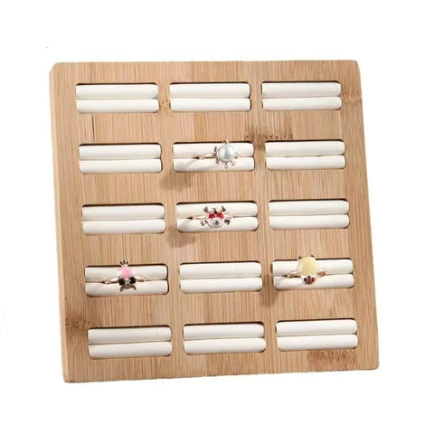 Straight Up The Coolest Wooden Ring Storage Tray With 15 Grids And Soft Velvet Lining To Keep Your Bling Organized On Vanity Or Dresser For Earrings And Bracelets displaying rings on a bamboo tray.