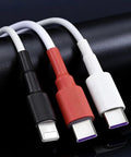Three USB cables in black, red, and white on a black surface