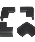 Four Piece Safety Corner Cushions For Baby And Home Protection With 3M Tape Easy To Install Made In USA BPA Free Latex Free Soft Yet Dense Foam Guard For Sharp Table Edges And Furniture, set of four black foam guards on white background.