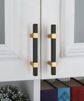 10 Pack 3 Inch Matte Black And Brass Cabinet Handles installed on white cabinet doors