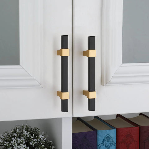 10 Pack 3 Inch Matte Black And Brass Cabinet Handles installed on white cabinet doors