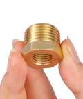 Brass 1/2 in NPT male to 1/4 in NPT female reducer hex bushing, threaded pipe fitting, close-up view.