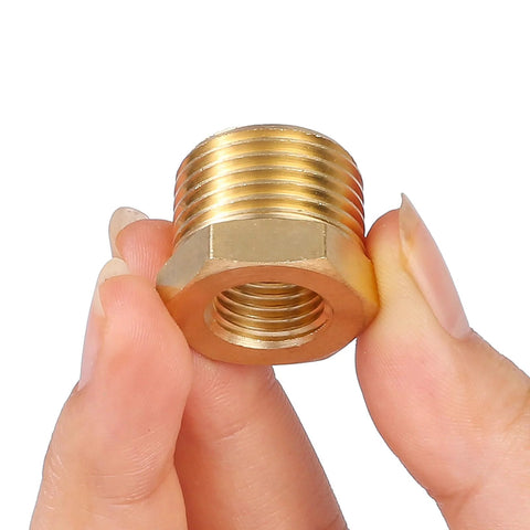 Brass 1/2 in NPT male to 1/4 in NPT female reducer hex bushing, threaded pipe fitting, close-up view.