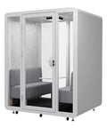 Hella Spacious Mobile Soundproof Office Pod Booth with glass entry, gray seating, and roller base for two to four people.