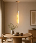 Alabaster Pendant Light Natural Marble Long Tube Hanging Lights with Wood Ceiling Canopy Modern Nordic Mini Pendant Lamp for Kitchen Island Bedroom Hallway(25 * 6cm) illuminating a dining table.