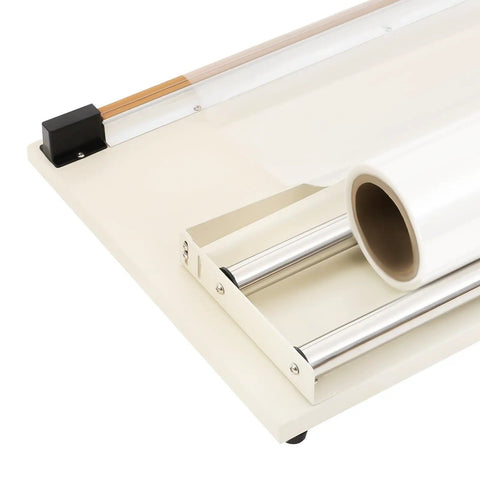 Top Tier 24 Inch Shrink Wrapping Station featuring a roll of plastic film and cutting bar setup for packaging.