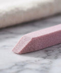 Close-up of pink pumice stick from Stone Nail File Set With Pumice Stick And Cuticle Pusher For Fingernails And Toenails Care