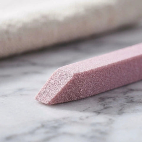 Close-up of pink pumice stick from Stone Nail File Set With Pumice Stick And Cuticle Pusher For Fingernails And Toenails Care