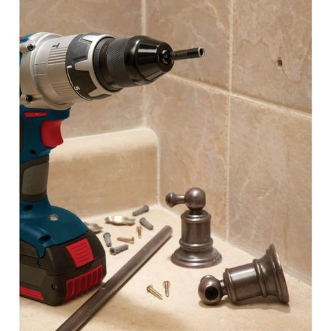 Bosch HDG12 1/2 in diamond hole saw mounted on a cordless drill beside tiled wall and plumbing fittings.