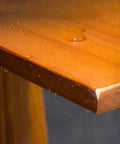Close-up of solid wood shelf detail showcasing water beads on surface, part of Industrial Iron Pipe Wine Rack For Home Bar Flex.