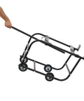 Heavy Duty Steel Drum Cradle Cart With Surefooted Wheels And Snappy Retractable Dump Bar being pulled, designed for 55 gallon barrels.