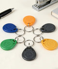Multi-colored Plug And Play Writable 125KHz RFID Fob Tags With T5577 Chip For Reusable Access Control Cards arranged in a circle
