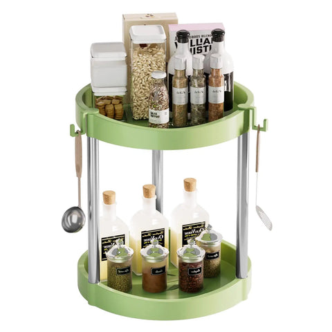 Two Tier 360 Degree Rotating Lazy Susan Spice Rack Organizer For Kitchen Countertop And Cabinet Pantry Storage Open Top With Guard Rails Extra Large 10 Inch Turntable Pro Grade Thickened PP Build For Easy Access And Spill Resistant in green, filled with bottles and jars, hanging utensils visible.