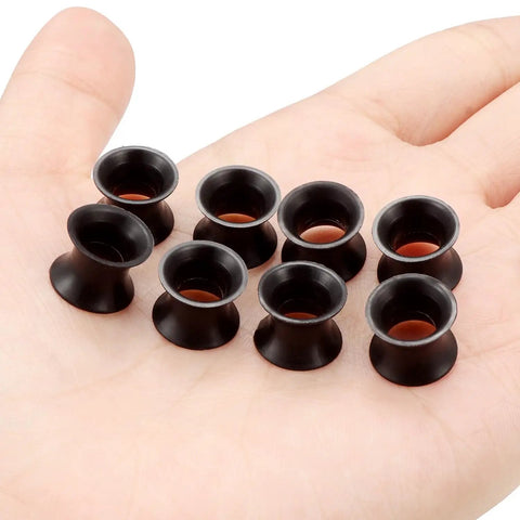 0G Black Silicone Ear Gauges Tunnels Plugs Set 8mm Ultra Thin Flexible Soft displayed on a hand