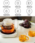 Keep Those Daily Brews Popping With This Touch Control Coffee Mug Warmer And Electric Cup Heater Featuring Dual Heat Settings For Flat Bottom Drinkware Fast Forty Nine Watt Warmth Plus Ten Hour Auto Shutoff To Ride The Comfort Wave Anytime, showing a glass teapot and cups on a heater.