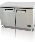Top Shelf Polished Stainless Steel 48 Inch Undercounter Work Top Freezer Featuring Rock Solid Forced Air Cooling Digital Temp Display Slick Design Ready To Roll, featuring dual doors and casters.