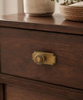 Top Shelf Antique Brass Cabinet Knobs With Killer Scalloped Backplates And Hella Durable Build For Fresh Kitchen And Bathroom Renovations Two Point Seven Five Inch Width Six Pack shown on wooden drawer.