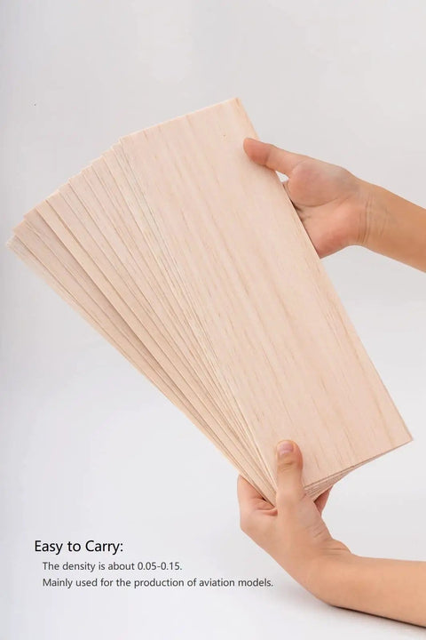 Hands holding Balsa Wood Sheets Bundle One Sixteenth Inch Thick 4 By 12 Inches Natural Unfinished Wood For DIY Crafts And Model Making