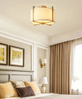 Dope Brushed Brass Four Light Flush Mount Ceiling Light With Drum Fabric Diffuser in bedroom setting