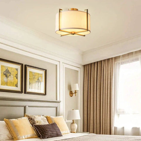 Dope Brushed Brass Four Light Flush Mount Ceiling Light With Drum Fabric Diffuser in bedroom setting