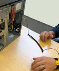 Person using Anti Static Wrist Strap Kit With 11 Inch Grounding Wristband, Alligator Clip, Extendable Long Cable, Adjustable 6 To 8.5 Inch Wrist, Protect Your PC From Static Shocks Like A Pro, connected to an open desktop computer on a table.