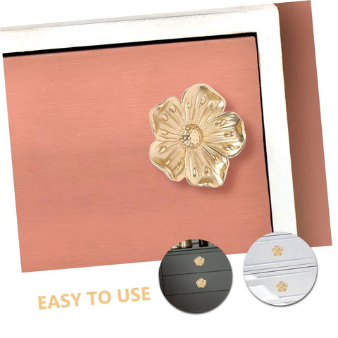 Close-up of brass flower cabinet handle set for wardrobe and dresser, single hole install, shown on drawer, retro decorative pulls
