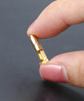 Close-up of a single gold tin-plated bullet connector from the 50 Pack Double Spade Wire Connectors For Motorcycle Wiring, 4mm size.
