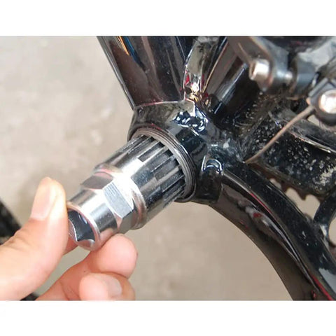 Heavy Duty Bike Bottom Bracket Removal Tool For Twenty Tooth Cartridges Fits Half Inch Drive Or Twenty Four Millimeter Wrench Perfect For Traditional Tapered BB Shimano Octalink And ISIS Splined Systems being used on a bike's bottom bracket