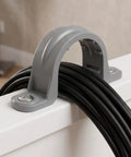 Thirty Pack Real Heavy Duty Three Quarter Inch Pvc Conduit Clamps flexible U clip supporting black cables on white surface.