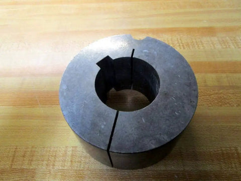 Metal Dodge Taper-Lock Bushing 117116 with 1-7/8 bore, 1/2 inch keyway, on wooden surface for power transmission equipment.