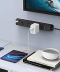 Surge Protector Power Strip With USB C Ports, 5 Outlets And 3 USB Ports, 1 USB C Port, mounted on wall with devices charging