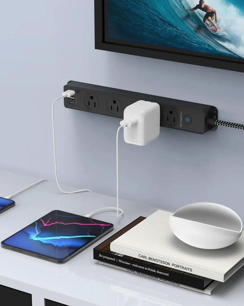 Surge Protector Power Strip With USB C Ports, 5 Outlets And 3 USB Ports, 1 USB C Port, mounted on wall with devices charging