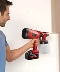 A person using a cordless paint sprayer featuring a powerful brushless motor and three adjustable patterns for flawless cabinet and fence finishing.