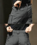 Back view of Mens Tactical Cargo Pants With Stretch Waterproof Fabric Durable Hiking And Work Pants Multi Pocket Cargo No Belt Dark Gray.
