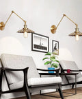 Dang Solid Industrial Wall Sconce With Adjustable Swing Arm And Vintage Bronze Metal Design For One Light E27 Farmhouse Living Room Decor on a wall above chairs.