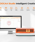 20W AI Smart Laser Engraver With HD Camera Positioning next to computer display showing design interface