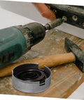 Built Tough Drill Press Quill Feed Return Spring And Replacement Coil Kit Heavy Duty Steel 2.04 By 1.75 Inches on workbench with tools.
