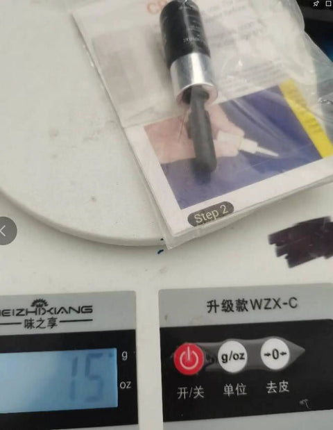 Windshield Repair Kit For Chips And Cracks, DIY Glass Filler For Automotive Glass on a digital scale showing 15 grams