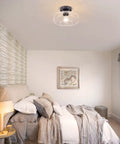 Bedroom with seeded glass shade flush mount ceiling light with matte finish for cozy modern vibe, showcasing retro charm.